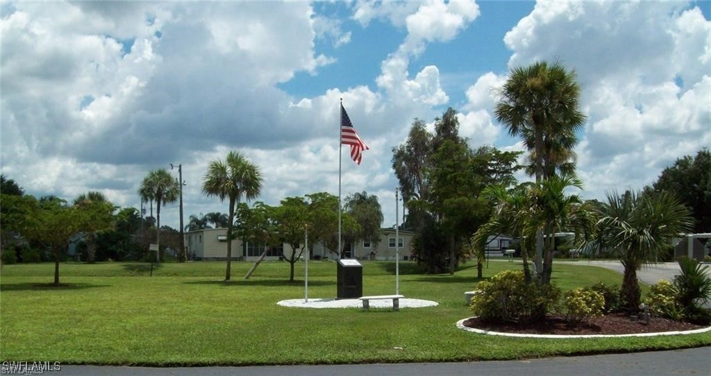 938 Lazy Lane North Fort Myers, FL 33917 - Photo 32 of 37 a park view with fountain in front of a brick building
