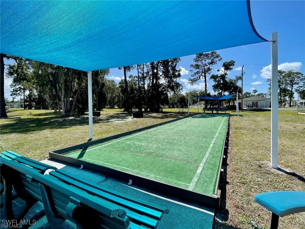 938 Lazy Lane North Fort Myers, FL 33917 - Photo 35 of 37 a view of a tennis ground with large trees