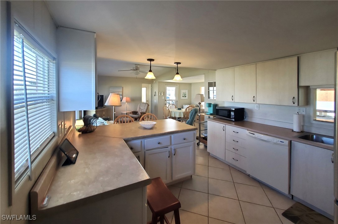 938 Lazy Lane North Fort Myers, FL 33917 - Photo 4 of 37 a kitchen with sink cabinets and appliances