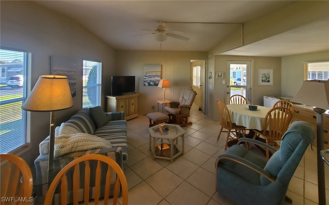 938 Lazy Lane North Fort Myers, FL 33917 - Photo 5 of 37 a living room with furniture and a lamp