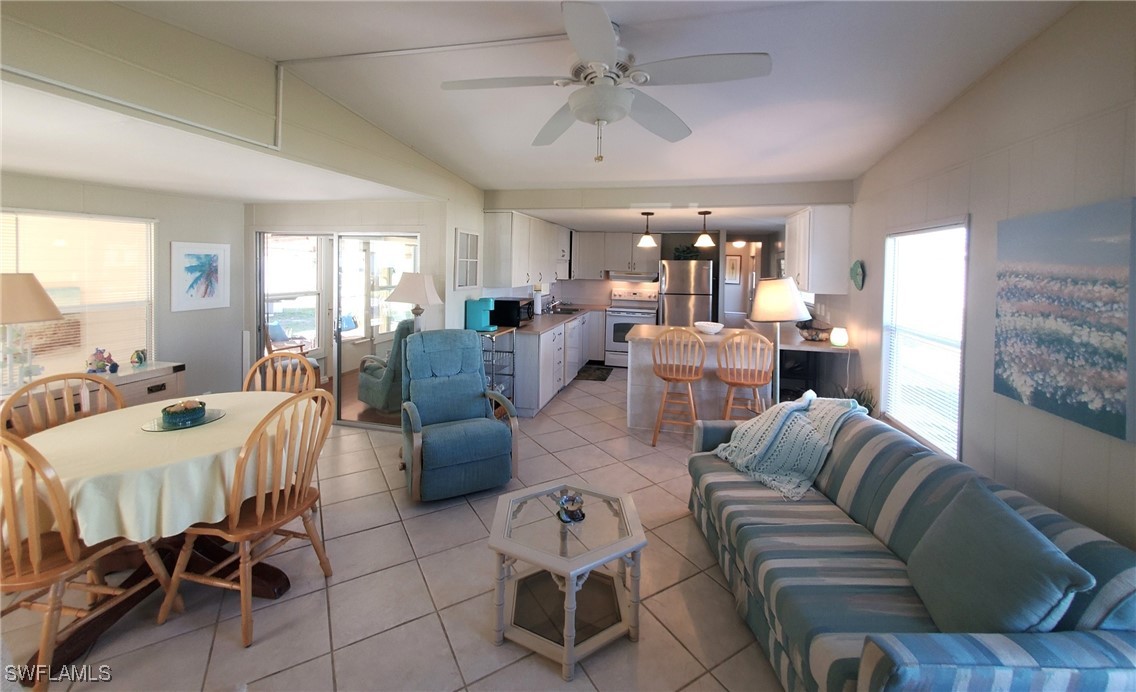 938 Lazy Lane North Fort Myers, FL 33917 - Photo 6 of 37 a living room with furniture and a chandelier