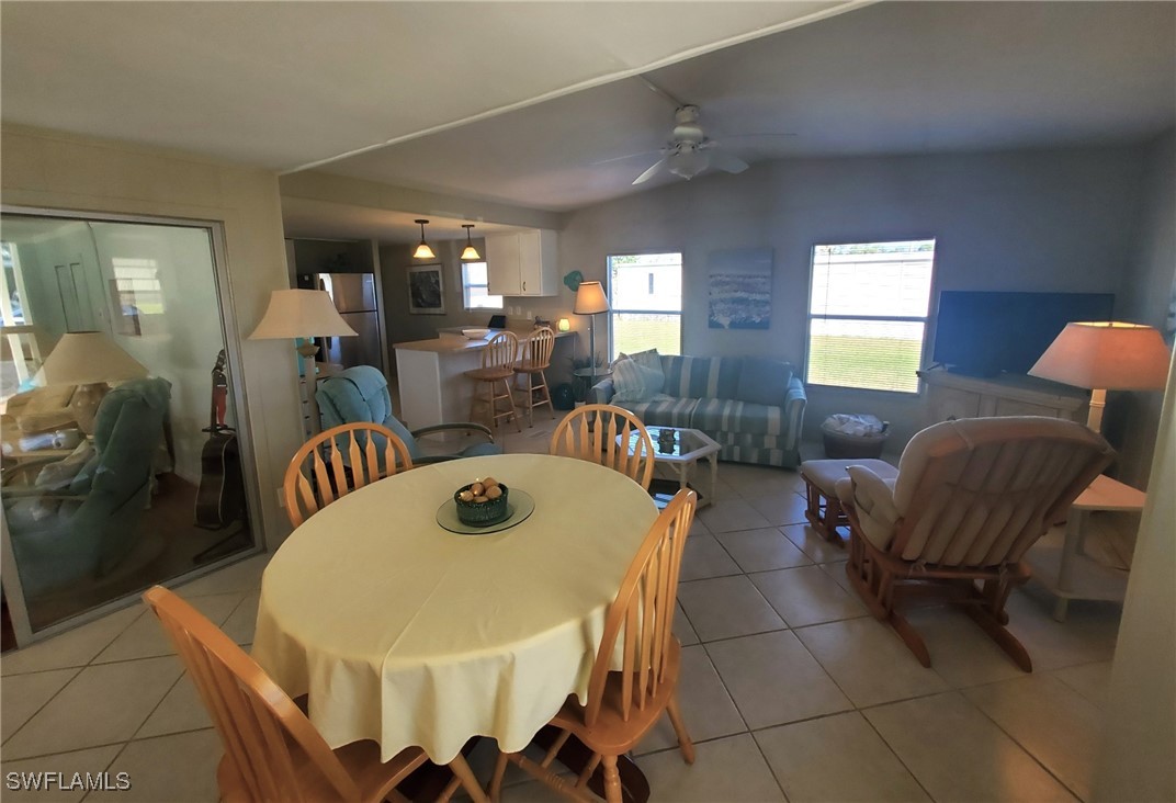 938 Lazy Lane North Fort Myers, FL 33917 - Photo 8 of 37 a view of a dining room with furniture and window