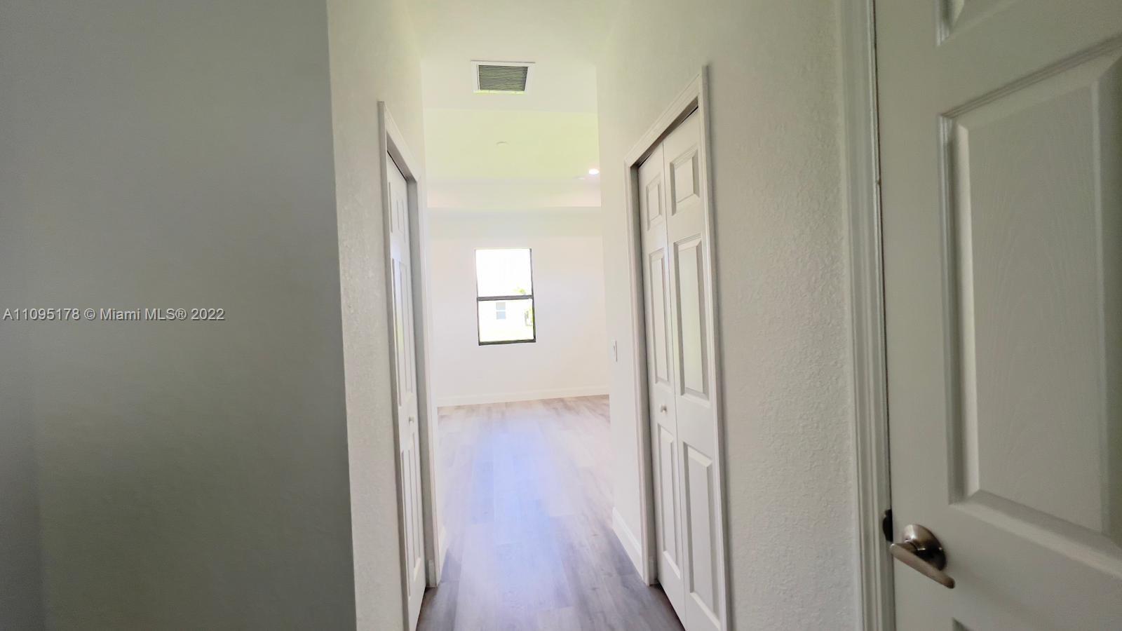 3911 Ordnance Road Lehigh Acres, FL 33971 - Photo 8 of 10 a view of a hallway with wooden floor