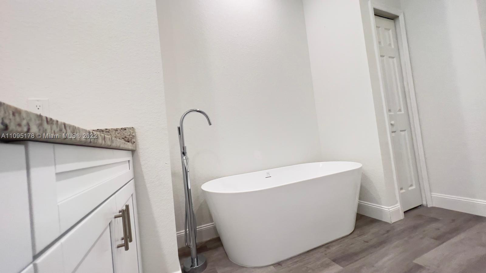 3911 Ordnance Road Lehigh Acres, FL 33971 - Photo 10 of 10 a bathroom with a bathtub and shower