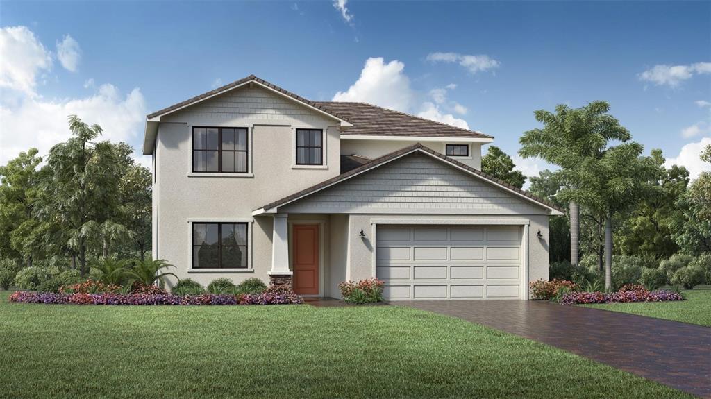 a front view of a house with a garden and yard