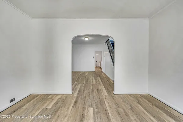 a view of a room with wooden floor and a sink