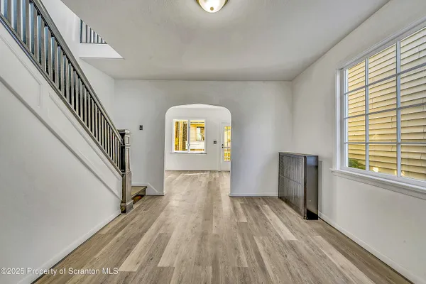 a view of a livingroom with wooden floor and stairs