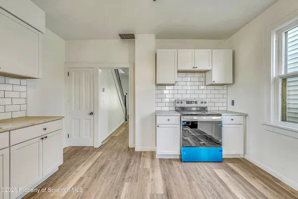 a kitchen with a stove and a refrigerator