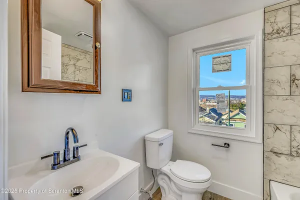 a bathroom with a toilet and a sink