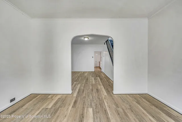 a view of a livingroom with wooden floor and stairs