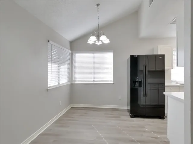 a kitchen with a sink cabinets and refrigerator