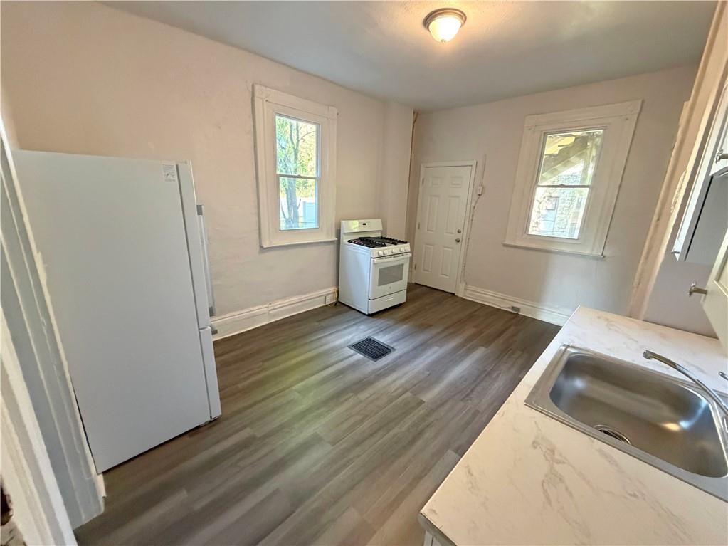7709 Bennett Street, Unit 1 Pittsburgh, PA 15208 - Photo 5 of 6 a bedroom with a bed and a window