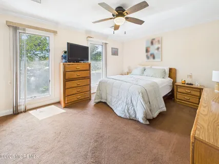 a bed room with a bed and a television