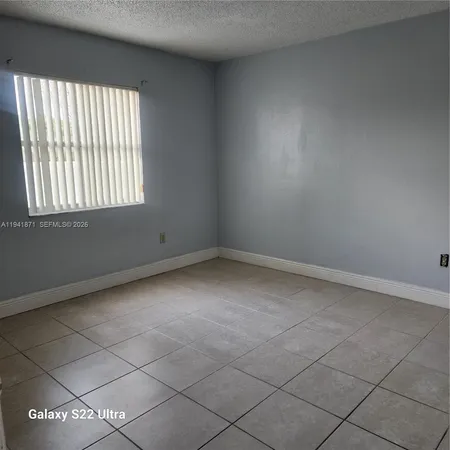 a bathroom with a granite countertop shower and a toilet