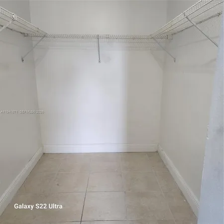 a kitchen with stainless steel appliances granite countertop a refrigerator and a stove