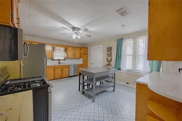 a large kitchen with a table and chairs