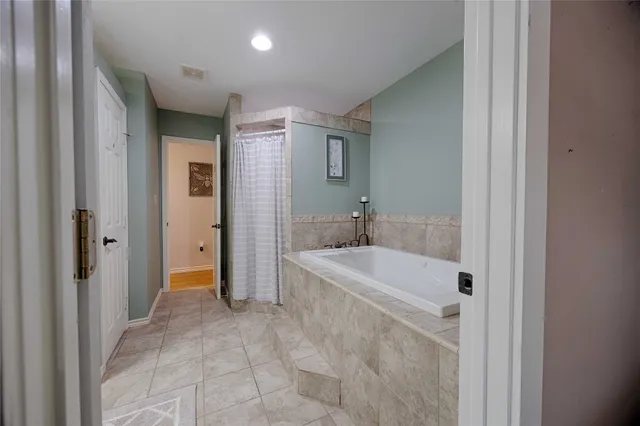 a bathroom with a bathtub and a sink
