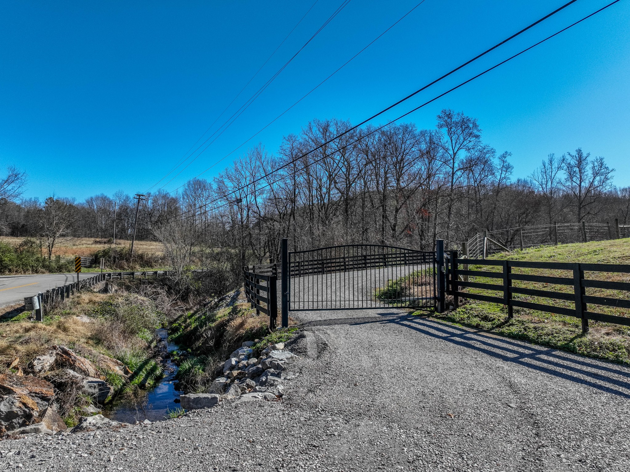 a view of a yard with wooden fence