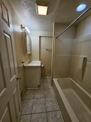 a bathroom with a bathtub and a sink