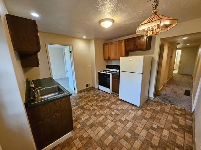 a kitchen with refrigerator and microwave