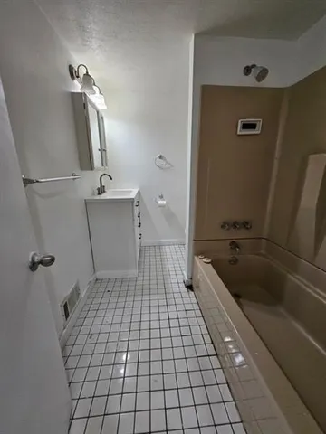 a bathroom with a sink a toilet and bathtub