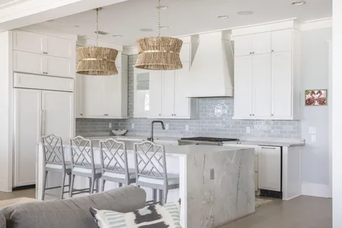 a kitchen with stainless steel appliances granite countertop a sink and a refrigerator