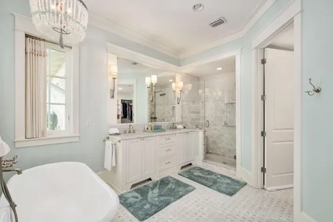 a bathroom with a granite countertop sink mirror and a bathtub