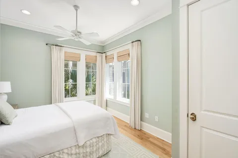 a bedroom with a large bed and a chandelier