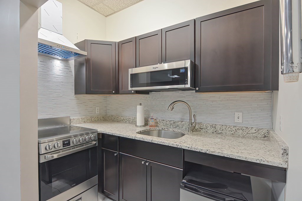 330 Sunderland Road, Unit 78 Worcester, MA 01604 - Photo 21 of 27 a kitchen with stainless steel appliances granite countertop a sink stove and microwave