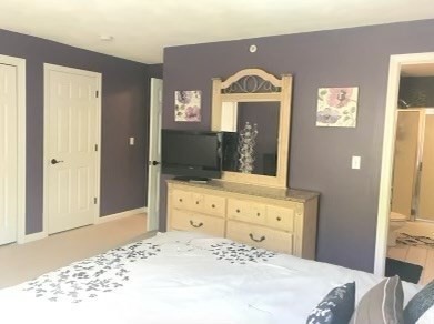 330 Sunderland Road, Unit 78 Worcester, MA 01604 - Photo 10 of 27 a bedroom with a bed and a dresser with mirror