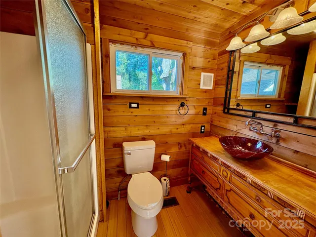 a bathroom with a granite countertop toilet sink and mirror
