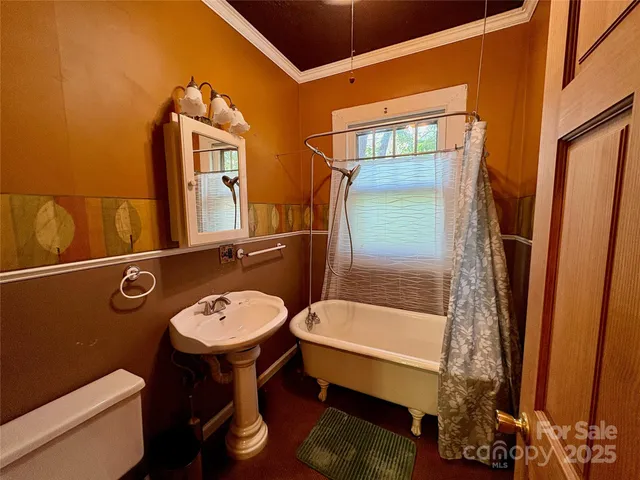 a bathroom with a sink a toilet and tub