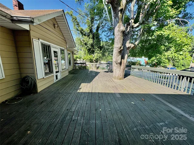 a view of a porch with wooden floor and fence