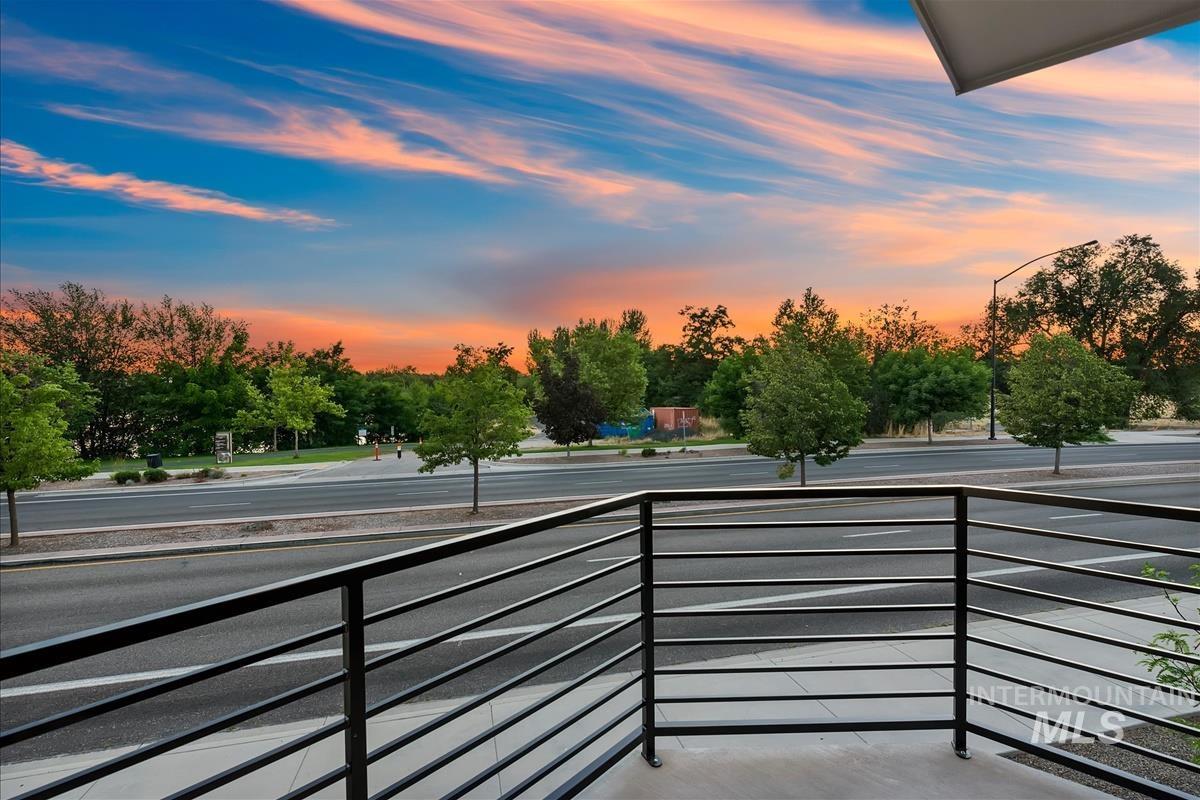 3219 West Moore Street Boise, ID 83702 - Photo 10 of 36 Balcony with metal railing overlooking a street and mature trees