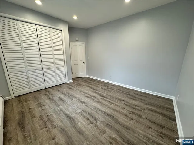 an empty room with wooden floor