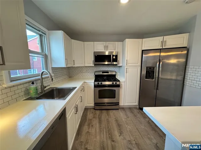 a kitchen with a refrigerator and a sink