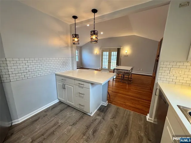 a view of a kitchen with sink and wooden floor
