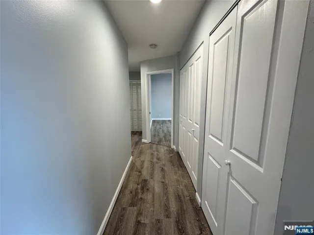 a view of a hallway with a hardwood floor