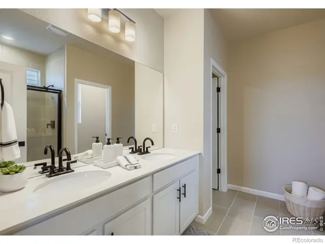 a bathroom with a shower and a glass door