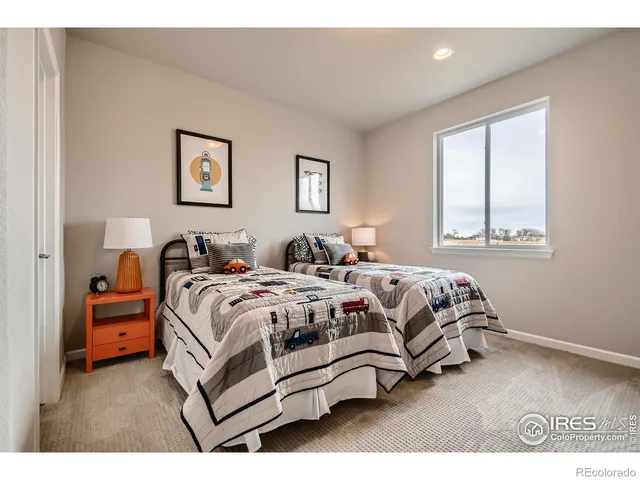 a bedroom with a bed and a lamp