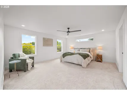 a bathroom with a double vanity sink a toilet a mirror and shower