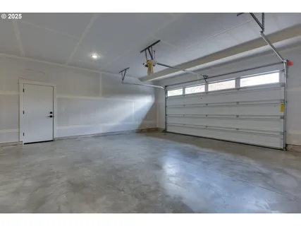 a bedroom with furniture and large windows