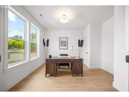 a view of a workspace with furniture and a window