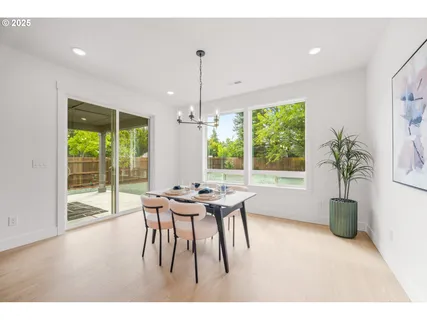 a dining room with furniture window plants and wooden floor