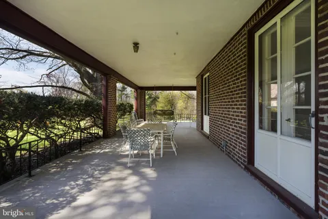 a view of a porch with chairs and backyard