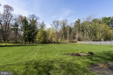 a view of field with trees in the background