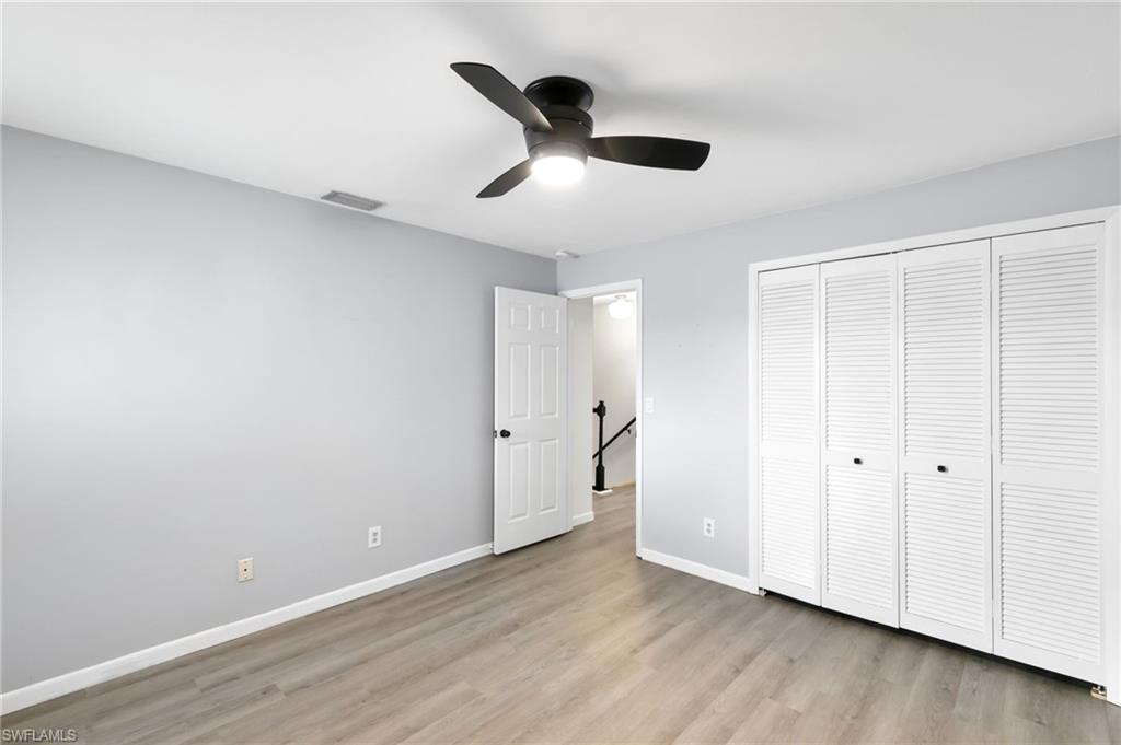 17017 Golfside Circle, Unit 404 Fort Myers, FL 33908 - Photo 14 of 22 a view of an empty room with wooden floor