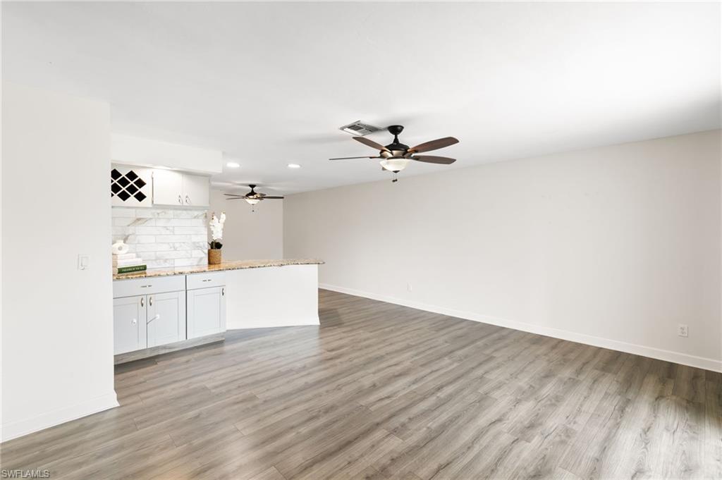 17017 Golfside Circle, Unit 404 Fort Myers, FL 33908 - Photo 2 of 22 a view of kitchen with wooden floor and window