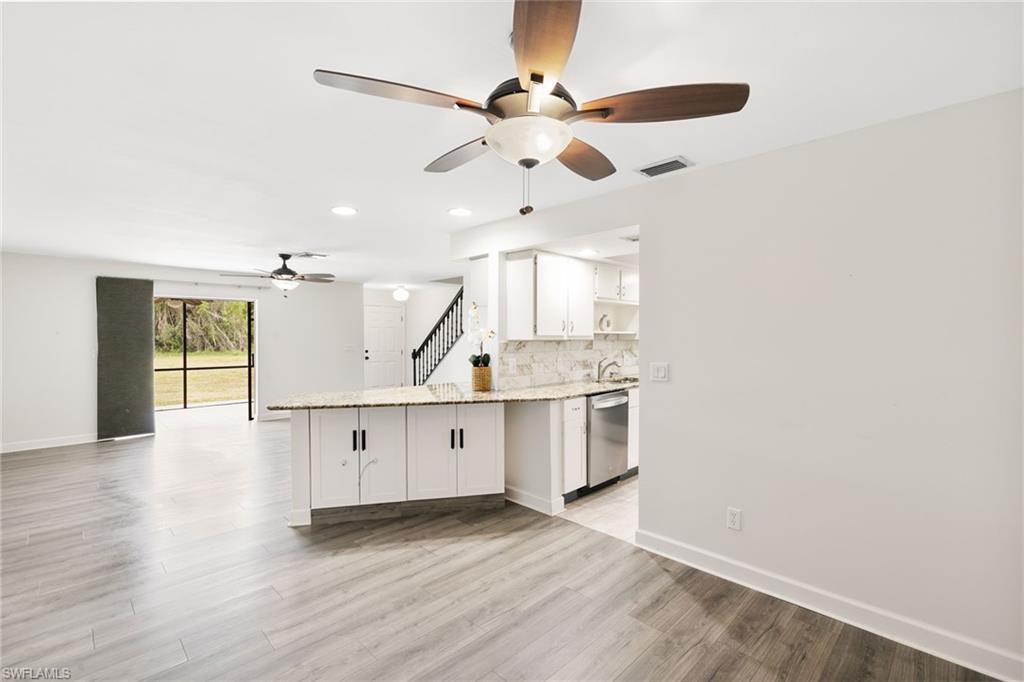 17017 Golfside Circle, Unit 404 Fort Myers, FL 33908 - Photo 7 of 22 a view of a kitchen with a sink and wooden floor