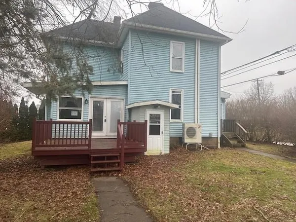 a view of a house with a yard and wooden fence